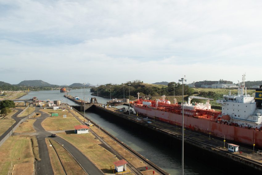 A boat making entry into the Miraflores Locks at the Panama Canal on a beautiful day.